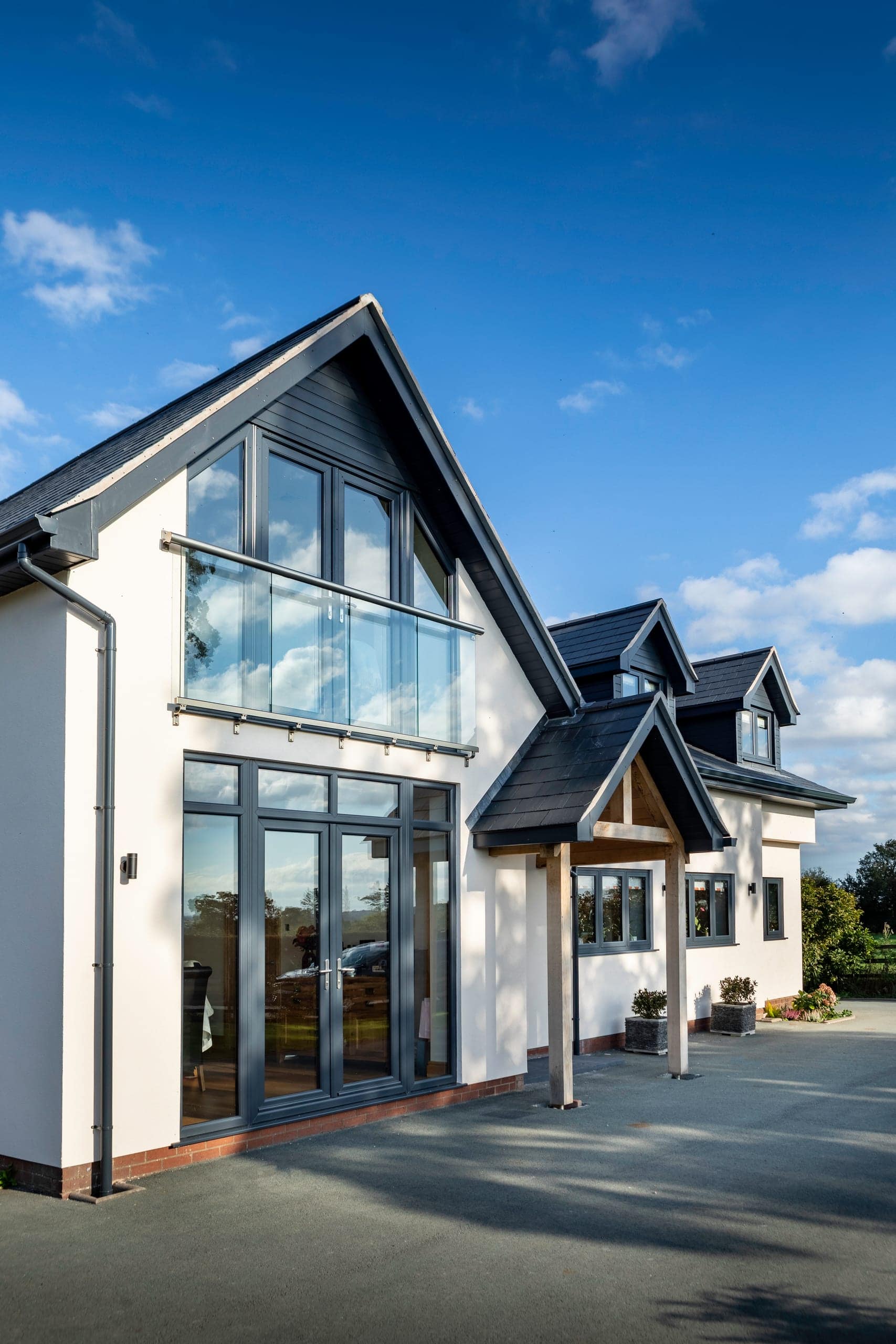 Rendered home with full-height gable glazing