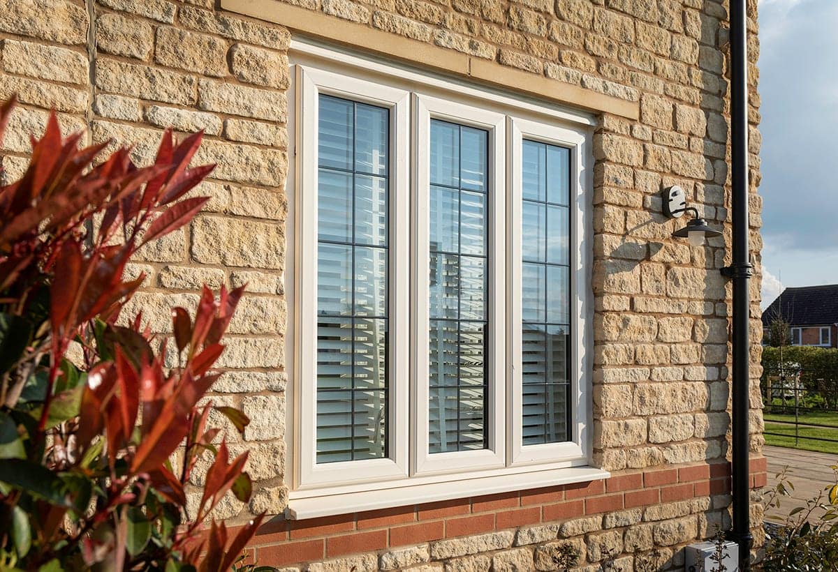 White uPVC casement window on a brick house