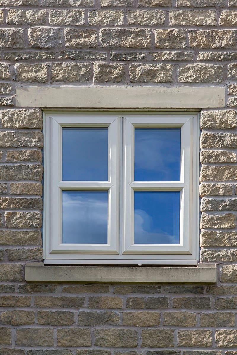 White uPVC casement windows on a stone-built house