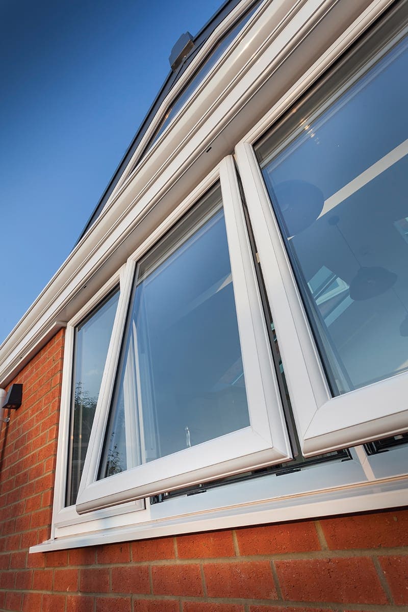 White uPVC window tilted open at the top for background ventilation