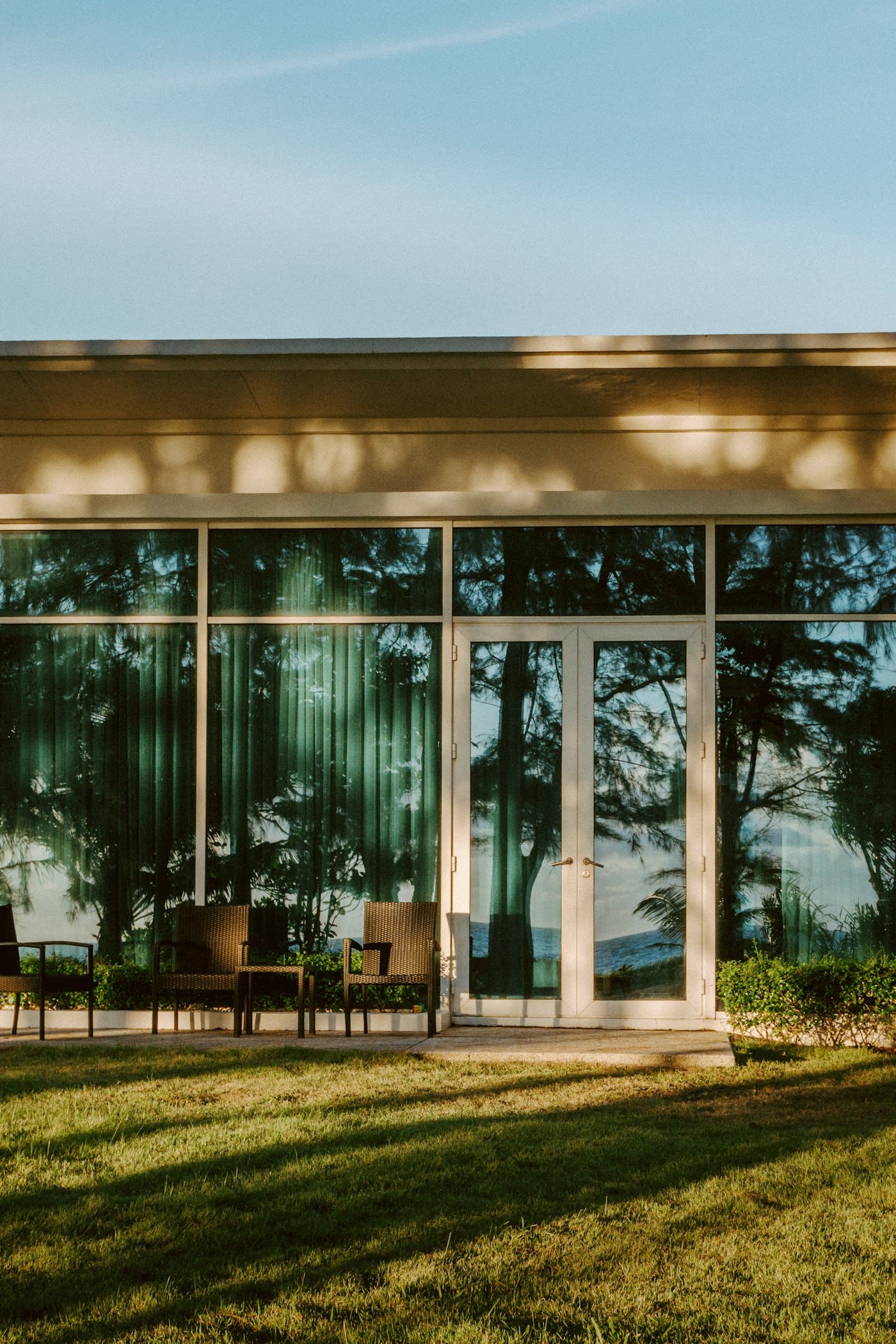 French doors and full-height glazing on a home overlooking a lawn
