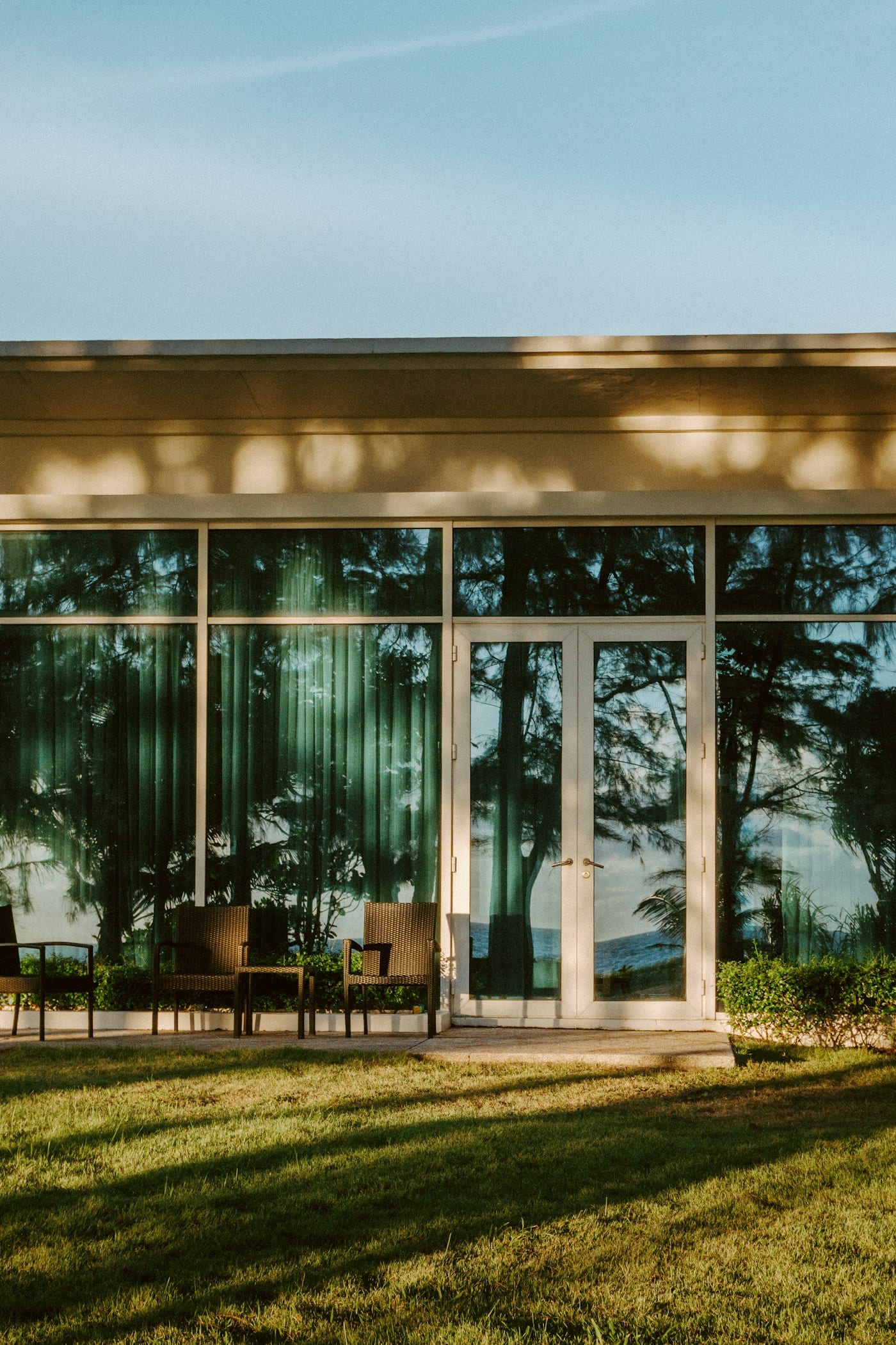 French doors and full-height glazing on a home overlooking a lawn