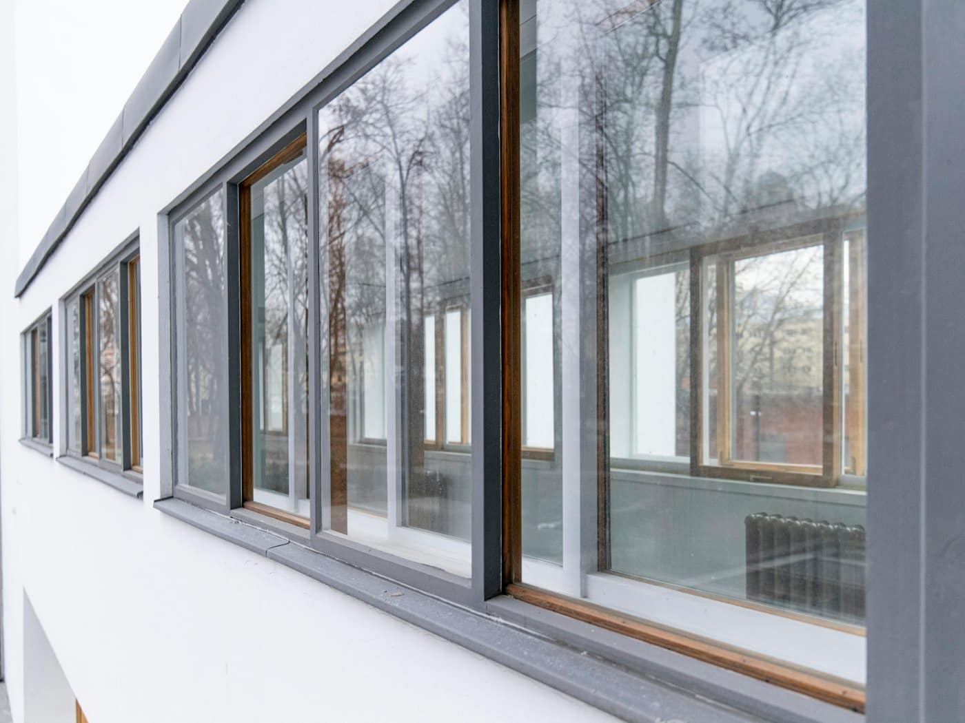 Row of slim grey-framed windows on a modern building