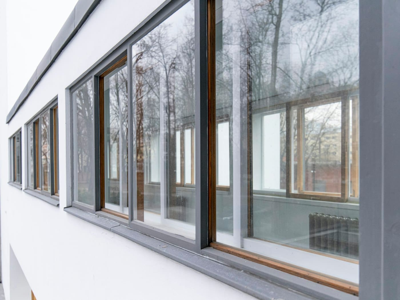 Row of slim grey-framed windows on a modern building