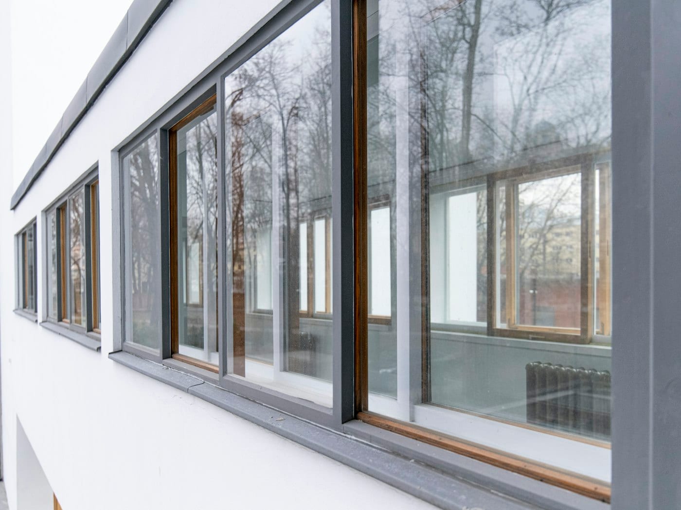 Row of slim grey-framed windows on a modern building