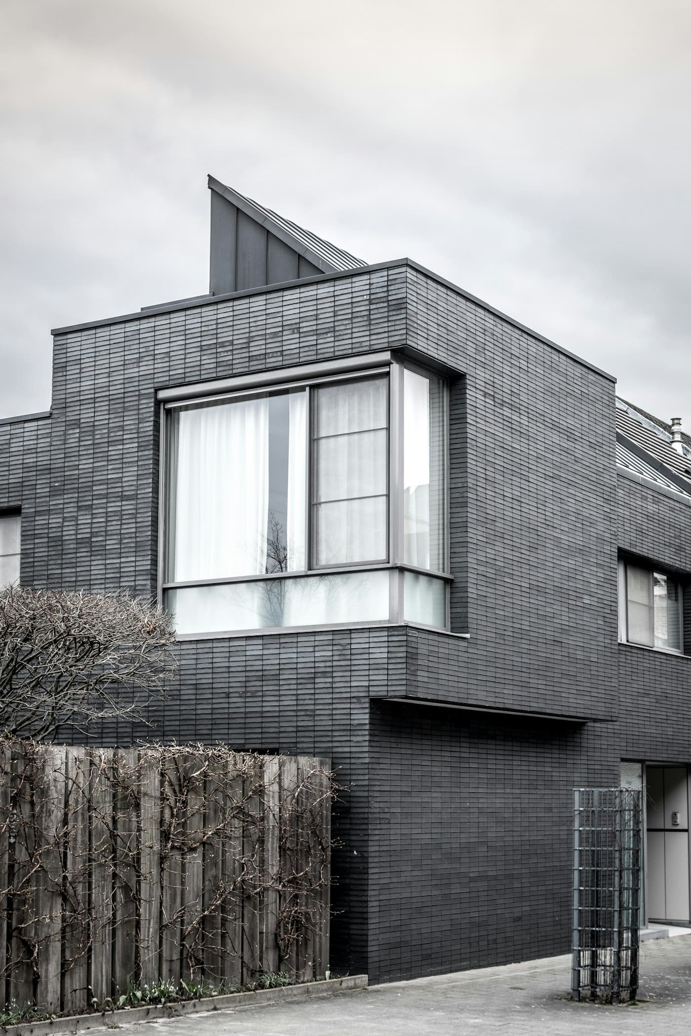 Modern grey-clad home with large aluminium-framed corner windows