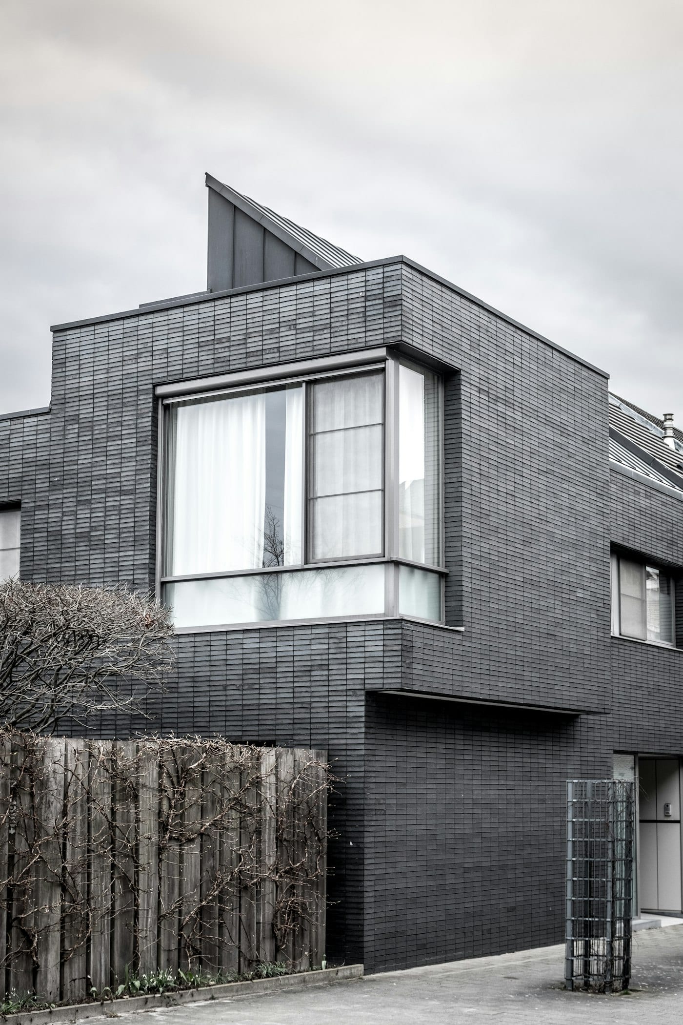 Modern grey-clad home with large aluminium-framed corner windows