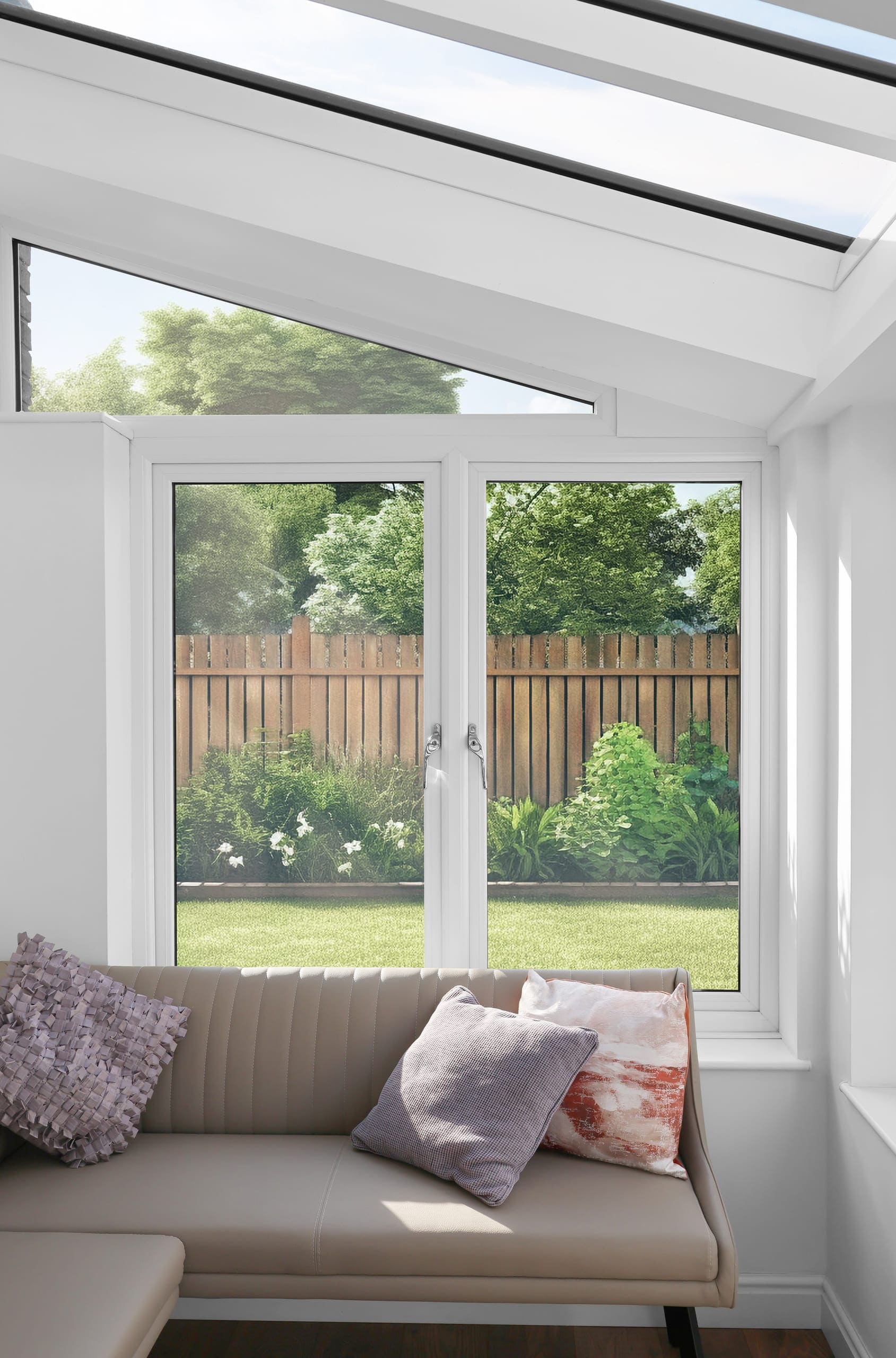 White French doors in a garden room looking onto the lawn