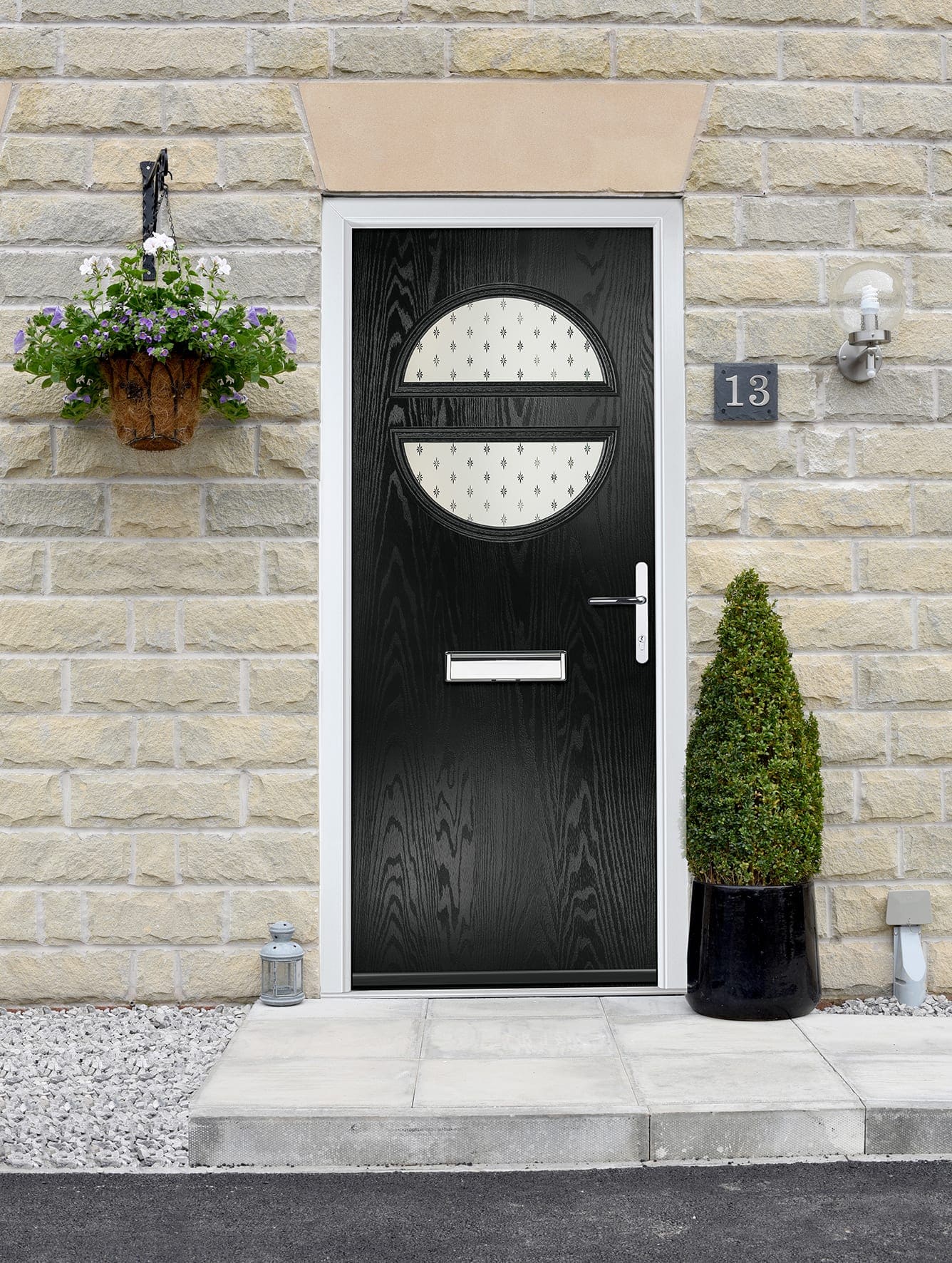 Black composite front door with an oval glazed panel