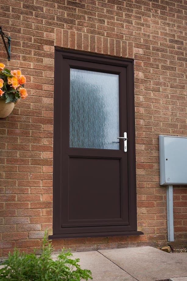 Rosewood-effect uPVC door on a brick house