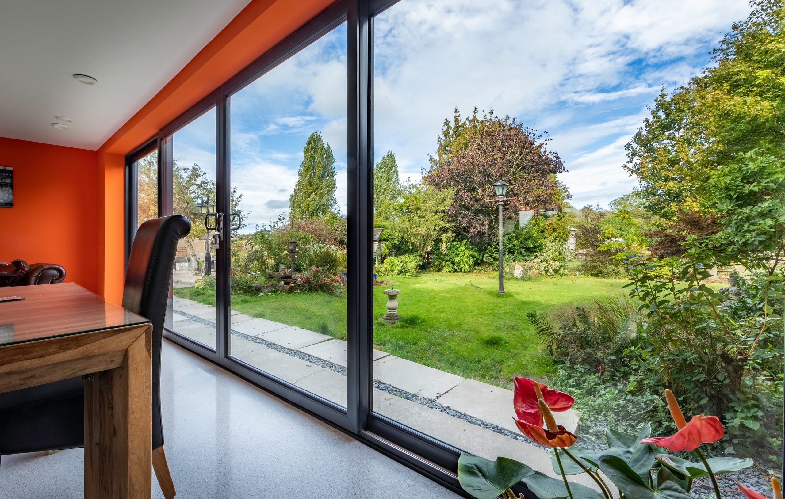 Large sliding doors framing the garden from a dining room