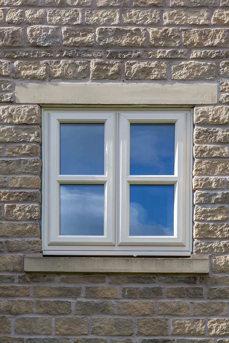 White uPVC casement windows on a stone-built house