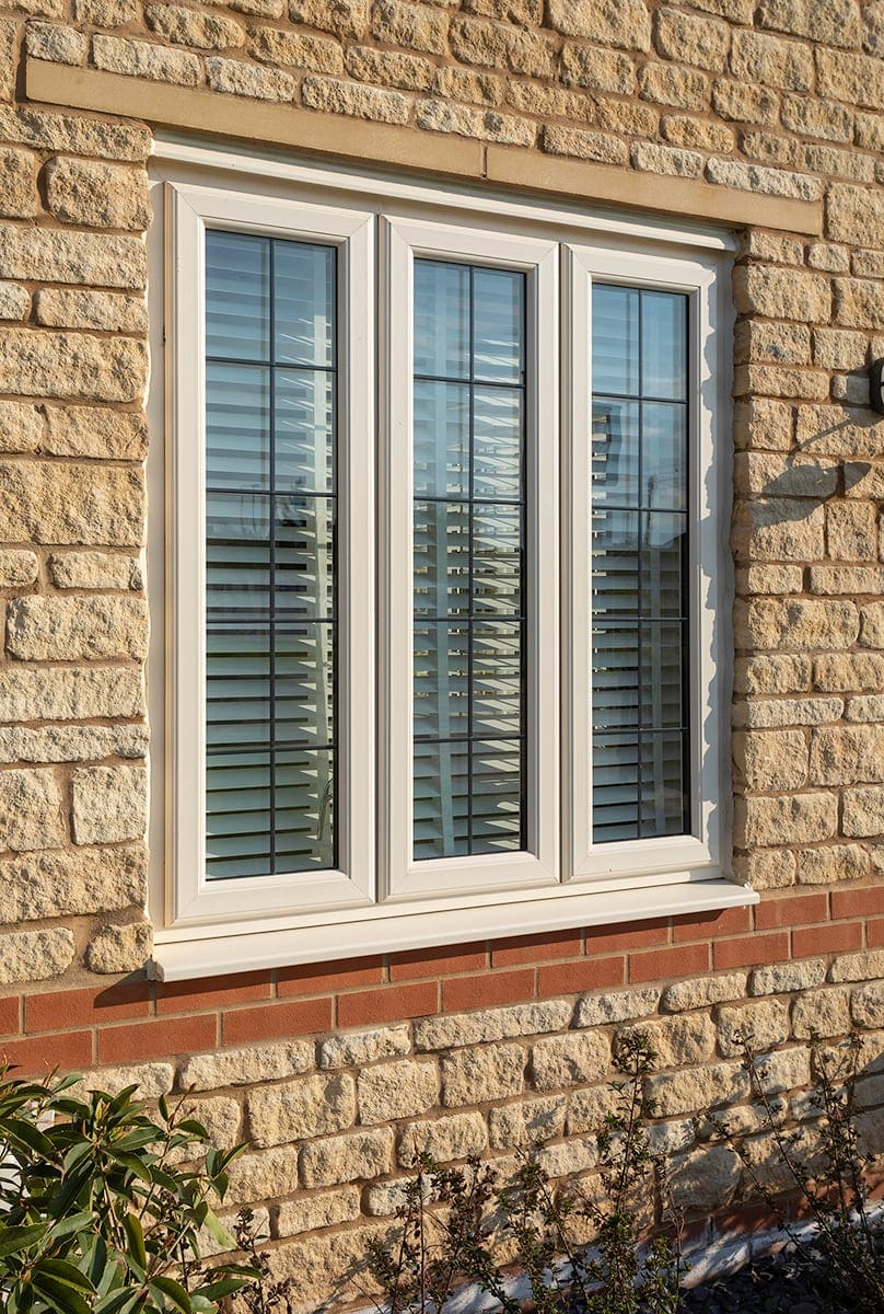 Cream uPVC casement window with shutters