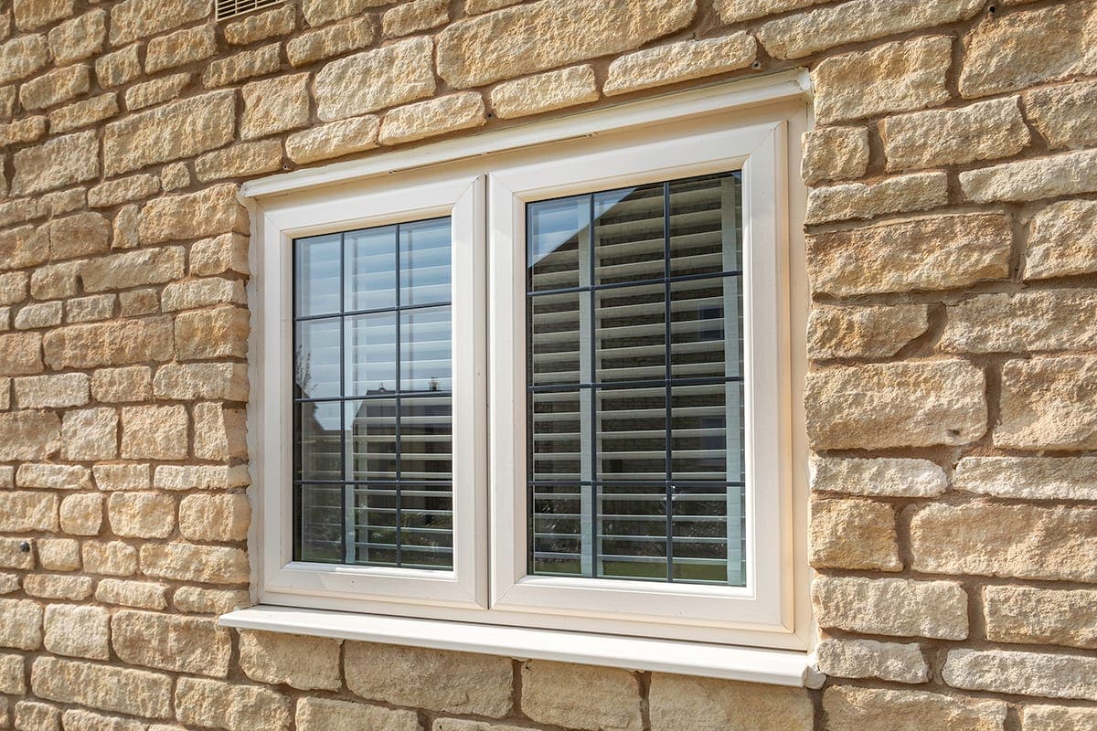 Cream uPVC casement window with internal blinds