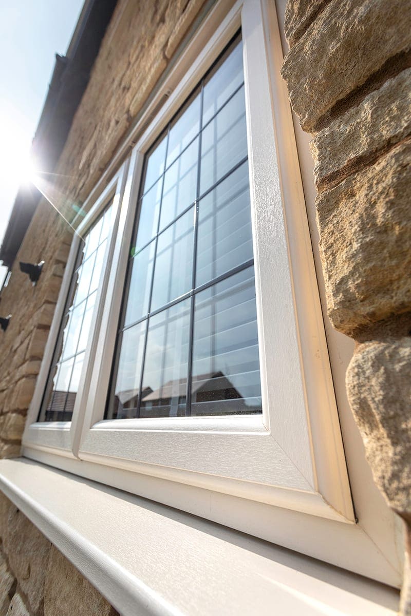 Leaded window tilted open on a stone house