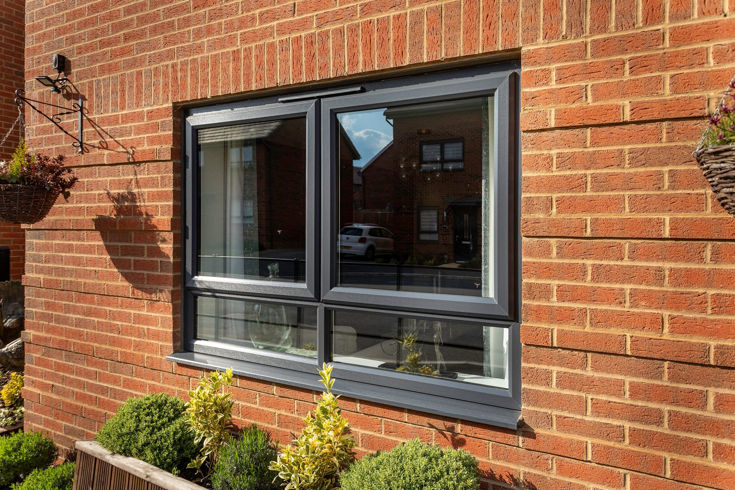 Grey aluminium window on a brick house